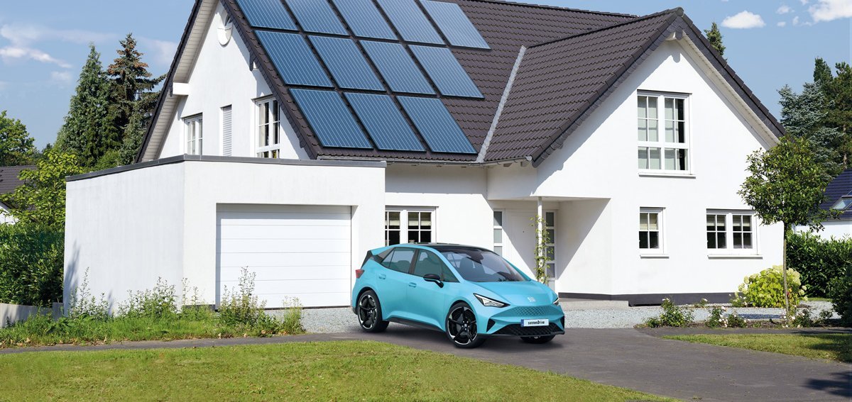 Haus mit Photovoltaikanlage auf dem Dach, Auto steht vor der Garage